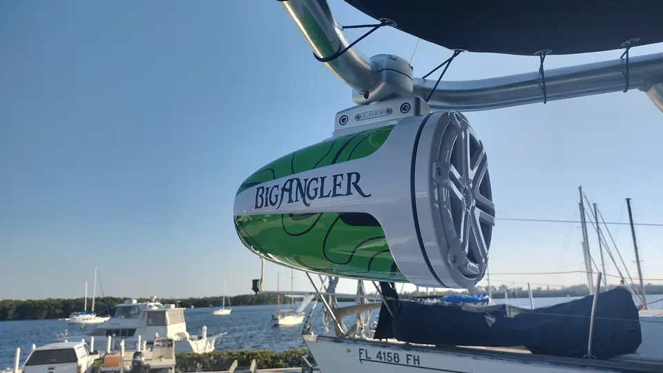 Tower speaker wrapped with the Big Angler logo above the marina