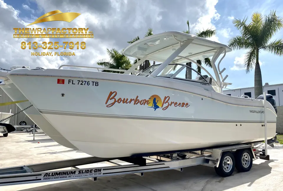 Dual console boat on a trailer with the Bourbon Breeze name in copper script