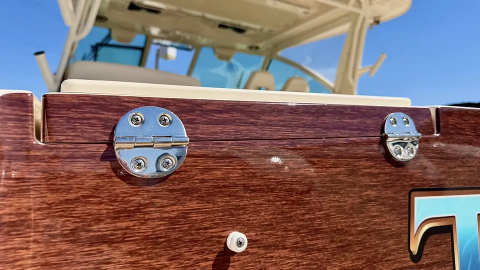 Faux-teak transom wrap detail around the stern hardware
