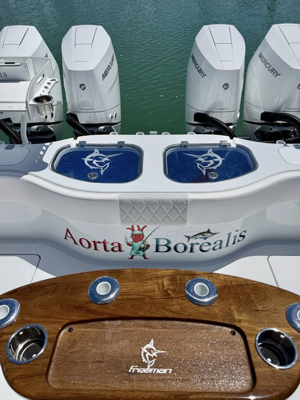 Freeman Boatworks 42 with the custom Aorta Borealis name above the quad outboards