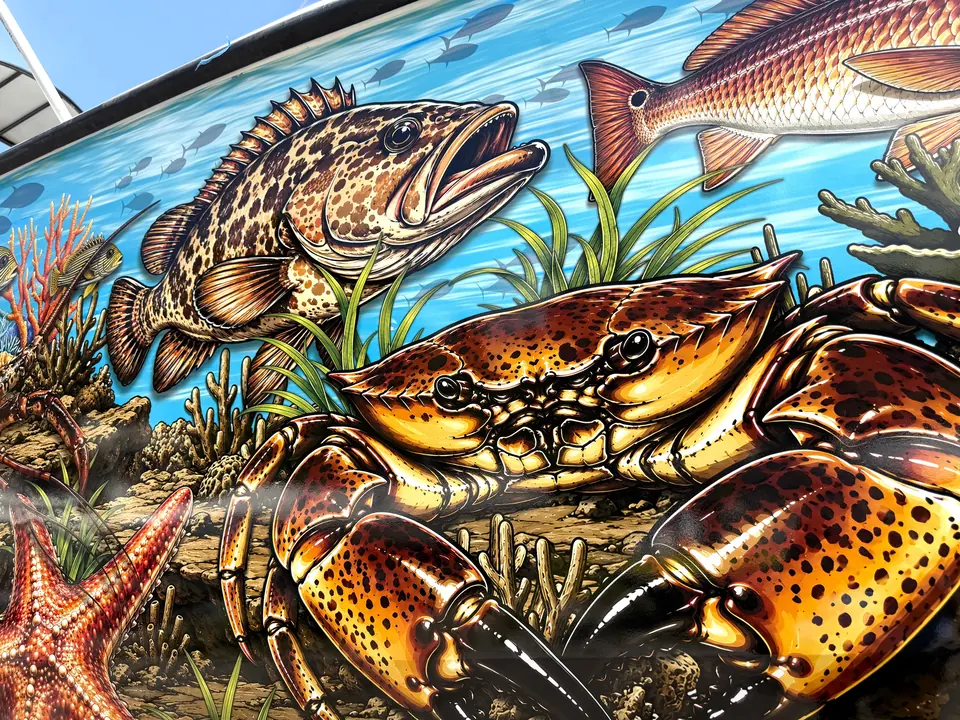 Detail of a grouper, stone crab and reef scene printed boat wrap