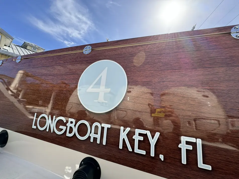 White Longboat Key, FL lettering and number 4 on a faux-teak transom