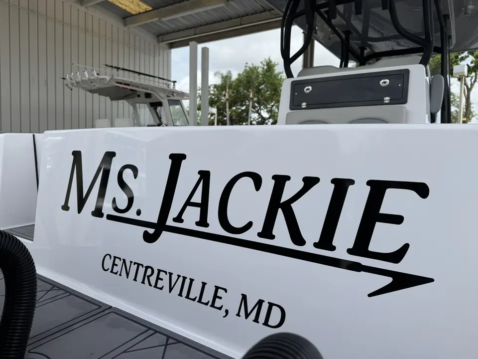 Black Ms. Jackie boat name with Centreville, MD hailing port on a white hull