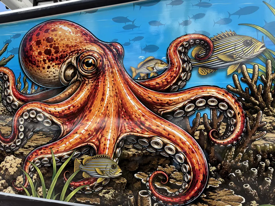 Detail of an orange octopus and reef fish printed boat wrap