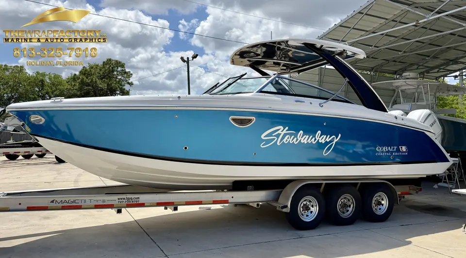 Cobalt bowrider named Stowaway with a two-tone blue hull wrap